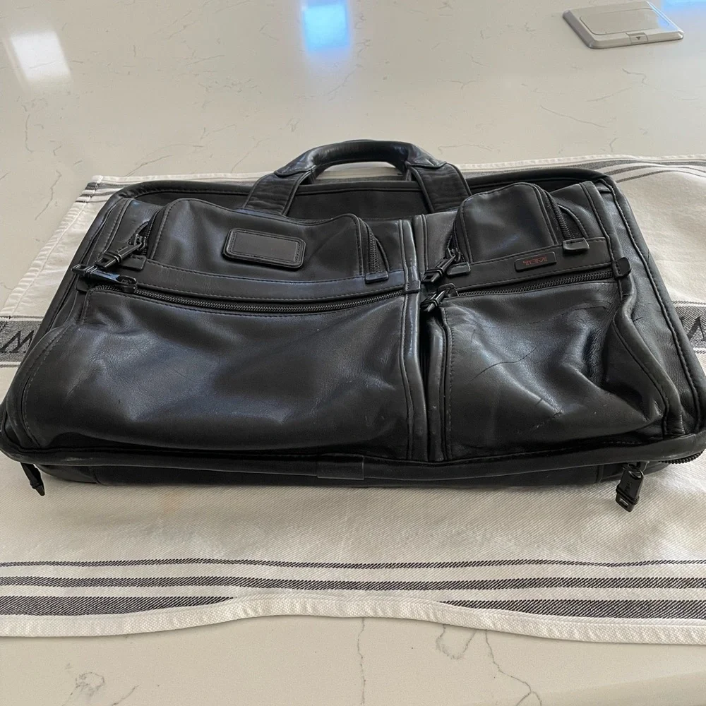 Tumi leather T pass medium laptop bag.Briefcase bag.Lots of pockets .